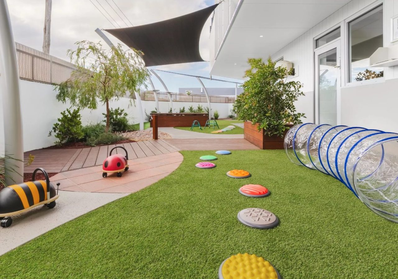 Kewdale Early Learning Centre landscaping - sensory stepping stones, play tunnel and artificial turf