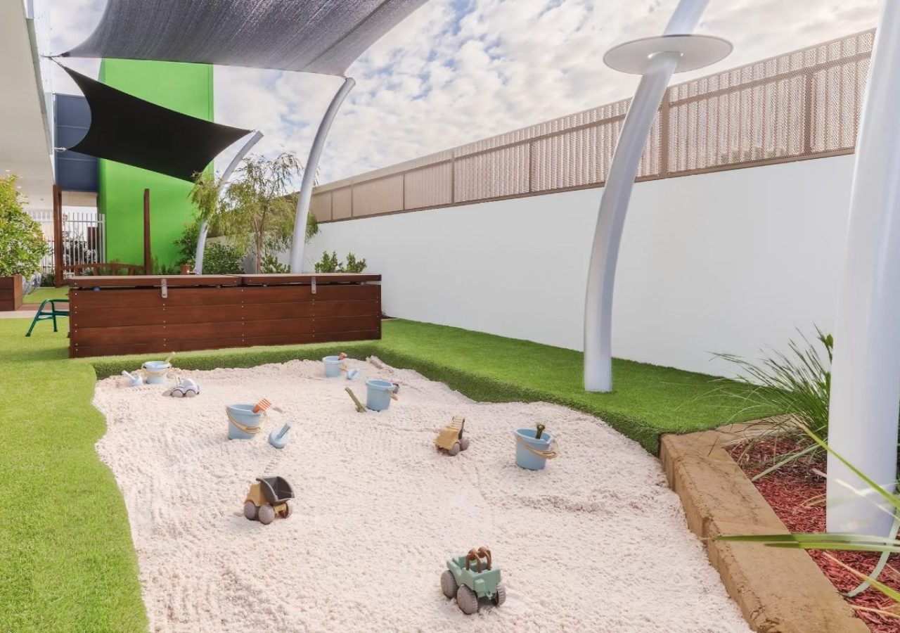 Kewdale Early Learning Centre landscaping - limestone block sandpit under shade sails