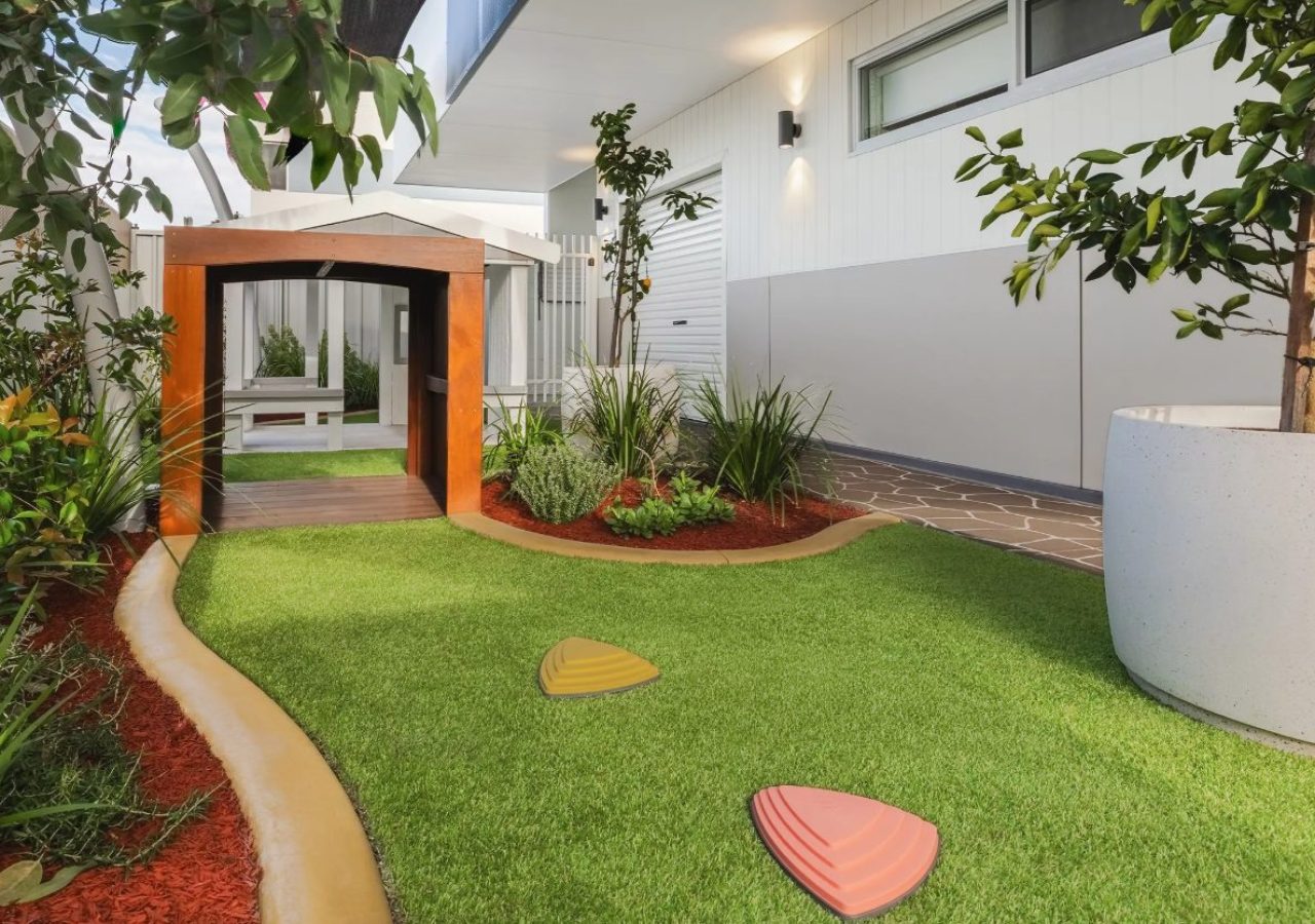 Kewdale Early Learning Centre landscaping - timber arbour entry, artificial turf and native planting
