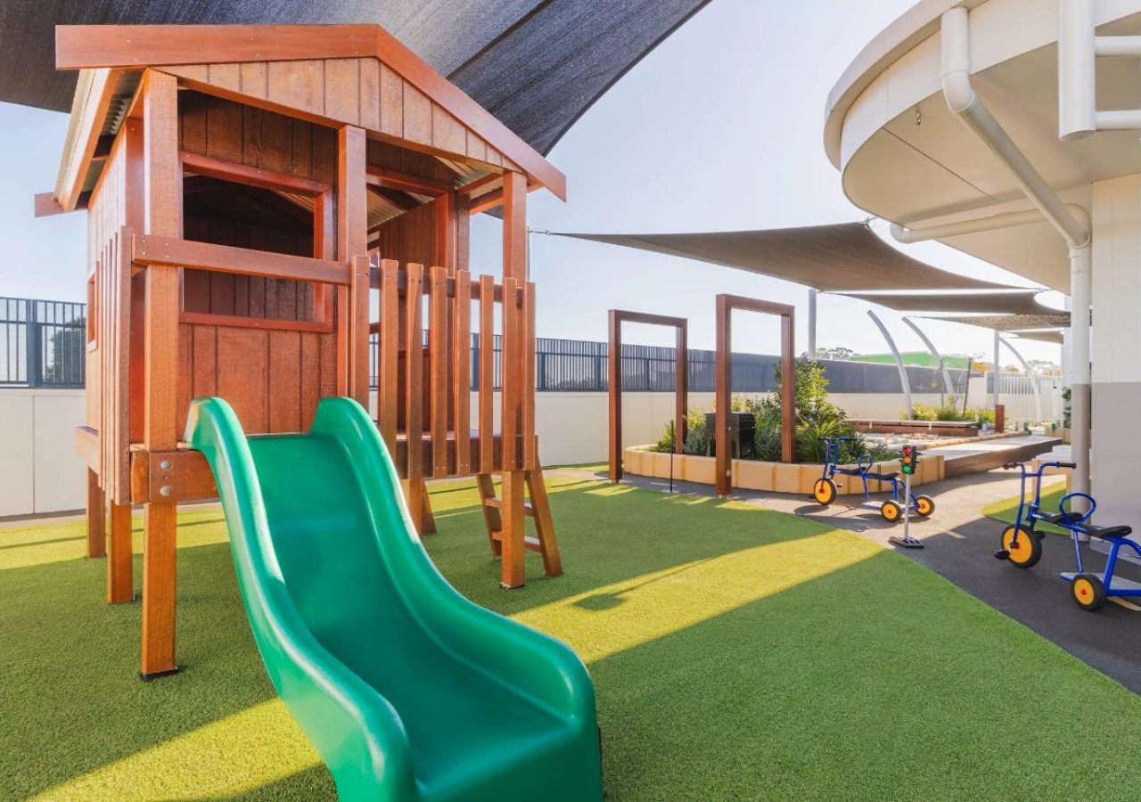 Kewdale Early Learning Centre landscaping - timber cubby house with slide